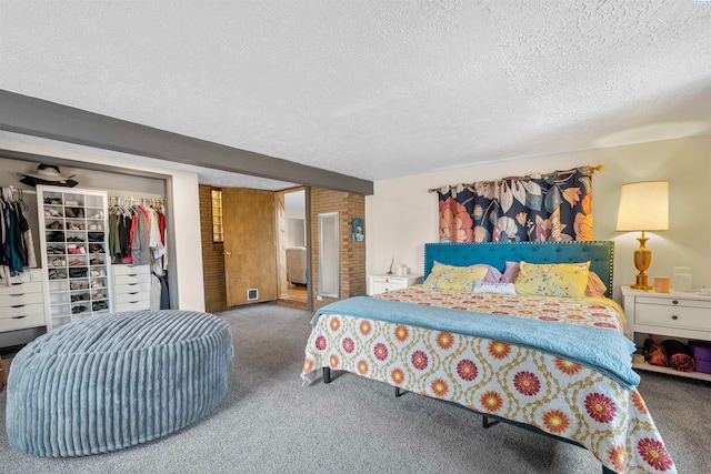 carpeted bedroom featuring a closet and a textured ceiling