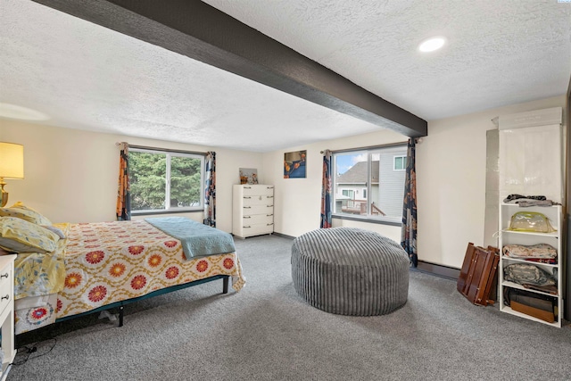 carpeted bedroom with beamed ceiling and a textured ceiling