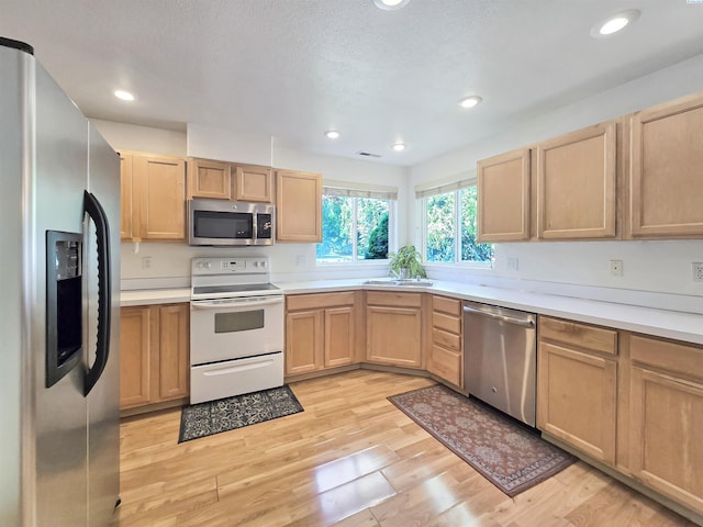 2650 Dornoch Pl, Richland, WA 99354 - kitchen featuring appliances with stainless steel finishes, light brown cabinets, light wood-type flooring, and recessed lighting