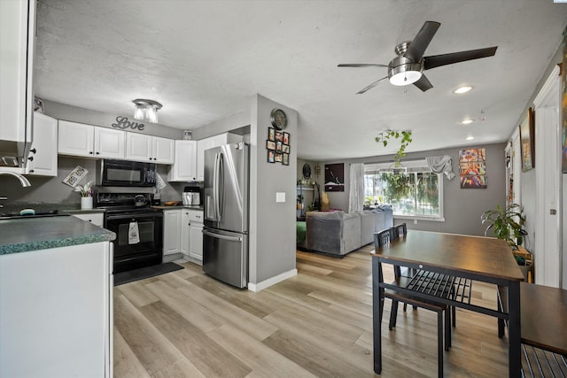 4403 S Ione St, Kennewick, WA 99337 - kitchen featuring black appliances, a sink, dark countertops, ceiling fan, and white cabinets