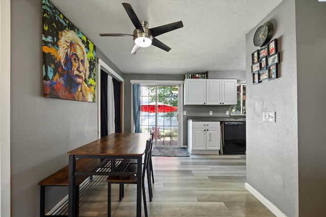 4403 S Ione St, Kennewick, WA 99337 - dining room featuring a textured wall, a ceiling fan, baseboards, light wood-type flooring, and a textured ceiling