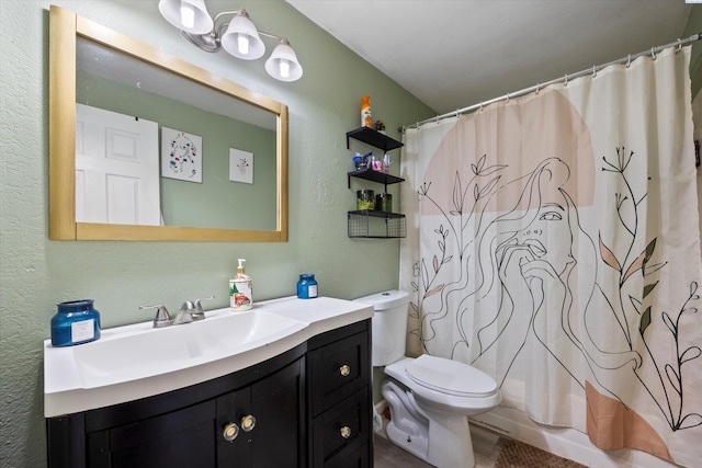 4403 S Ione St, Kennewick, WA 99337 - bathroom with vanity, toilet, a textured wall, a shower with curtain, and wood finished floors