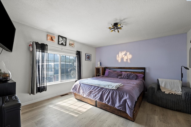 4403 S Ione St, Kennewick, WA 99337 - bedroom with wood finished floors, a textured ceiling, and baseboards