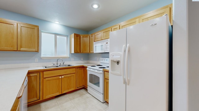 kitchen featuring white appliances and sink