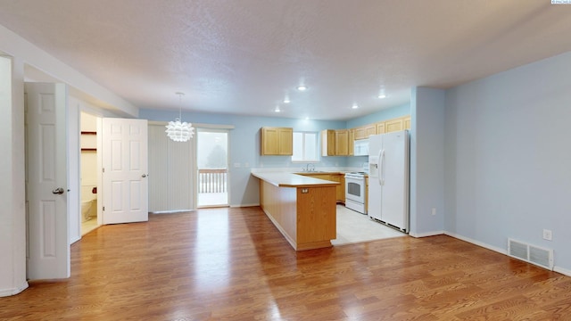 kitchen with pendant lighting, light brown cabinetry, light hardwood / wood-style floors, kitchen peninsula, and white appliances