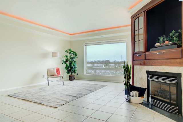 sitting room with light tile patterned floors and a tile fireplace