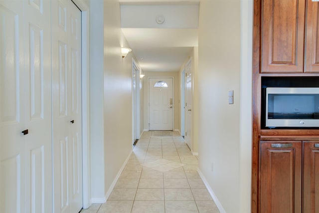 corridor with light tile patterned flooring