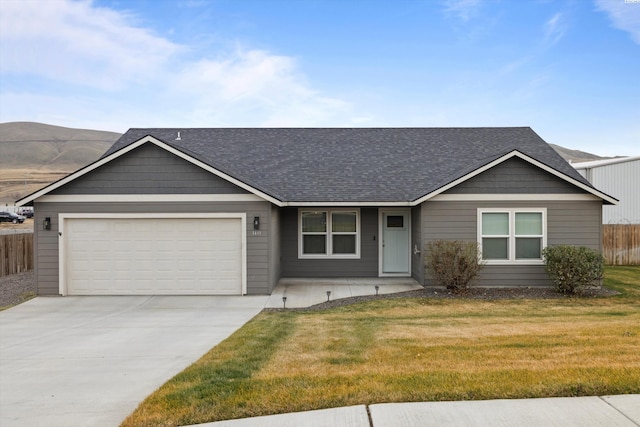 single story home featuring a garage and a front lawn