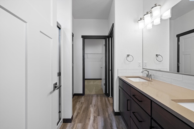 6701 Sockeye Ln, Pasco, WA 99301 - bathroom with hardwood / wood-style flooring, vanity, and decorative backsplash