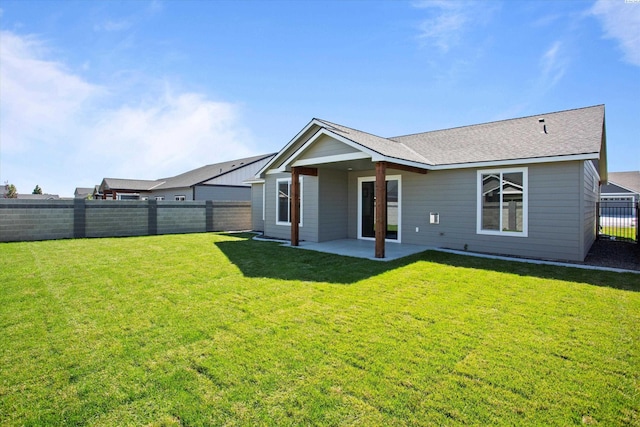 6701 Sockeye Ln, Pasco, WA 99301 - rear view of house featuring a patio and a lawn
