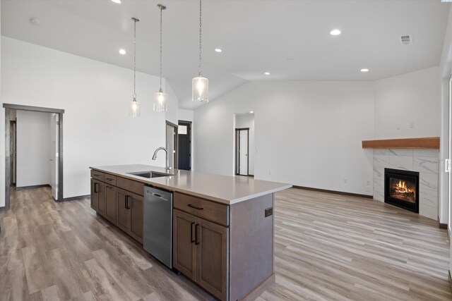 6701 Sockeye Ln, Pasco, WA 99301 - kitchen with pendant lighting, sink, dishwasher, a fireplace, and an island with sink