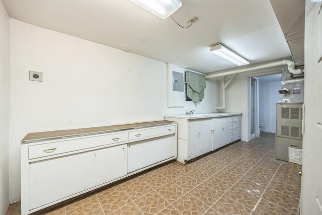 kitchen with white cabinets and electric panel