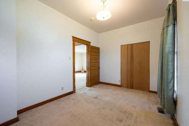 unfurnished bedroom featuring light carpet