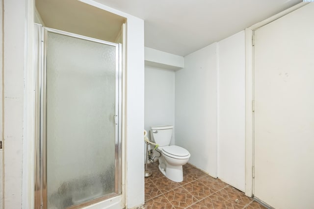 bathroom featuring toilet and walk in shower