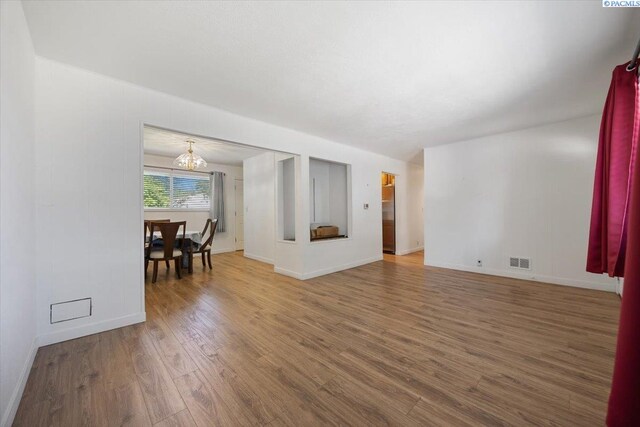 1925 Everest Ave, Richland, WA 99354 - unfurnished room with a chandelier, wood finished floors, and baseboards