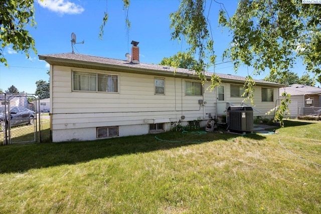 1925 Everest Ave, Richland, WA 99354 - back of property with central air condition unit, a chimney, and a gate