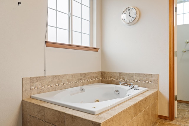 bathroom with a wealth of natural light and a relaxing tiled tub