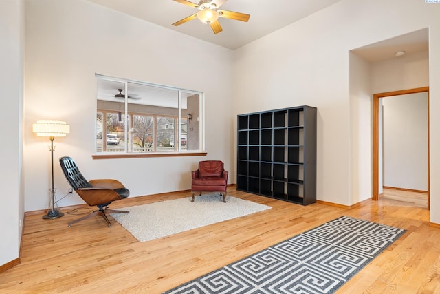 sitting room with light hardwood / wood-style floors and ceiling fan