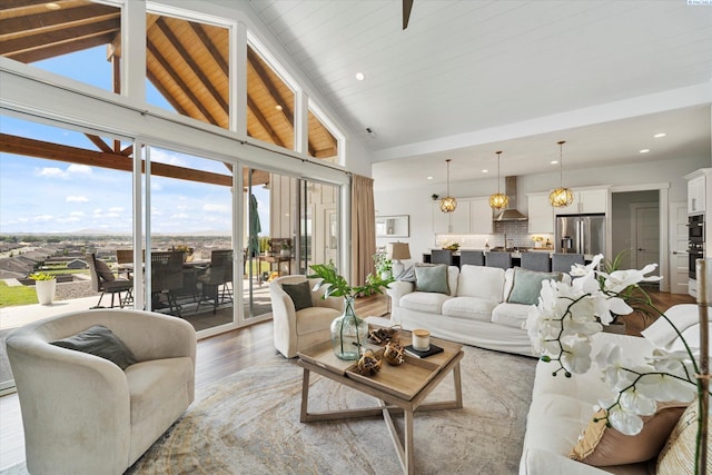 living room with beamed ceiling, wood-type flooring, and high vaulted ceiling