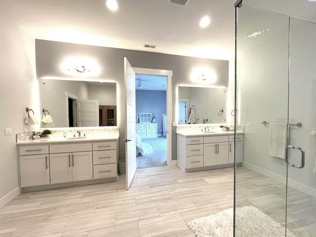 6514 Eagle Crest Dr, Pasco, WA 99301 - bathroom featuring two vanities, visible vents, baseboards, and a sink