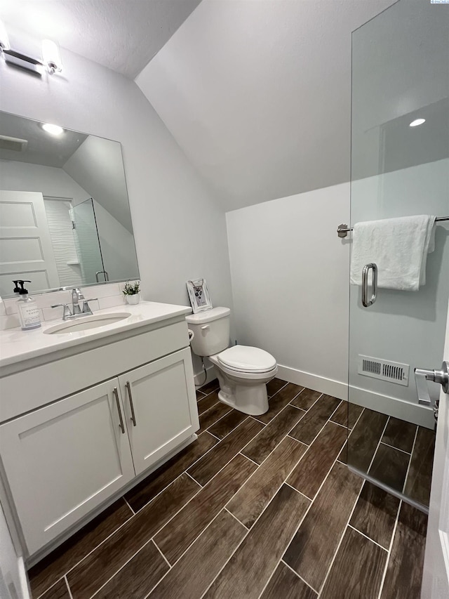 6514 Eagle Crest Dr, Pasco, WA 99301 - bathroom with vaulted ceiling, toilet, a shower with shower door, wood finish floors, and visible vents