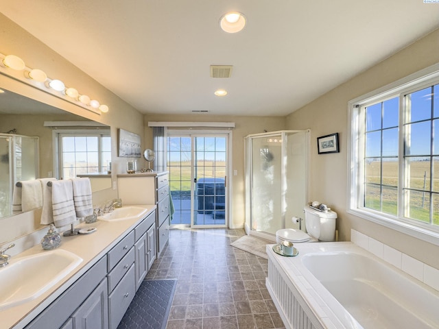 full bathroom featuring vanity, toilet, and separate shower and tub