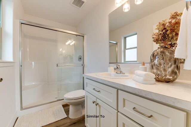 2880 S Osborne St, Kennewick, WA 99338 - bathroom with vanity, a stall shower, toilet, visible vents, and wood finished floors