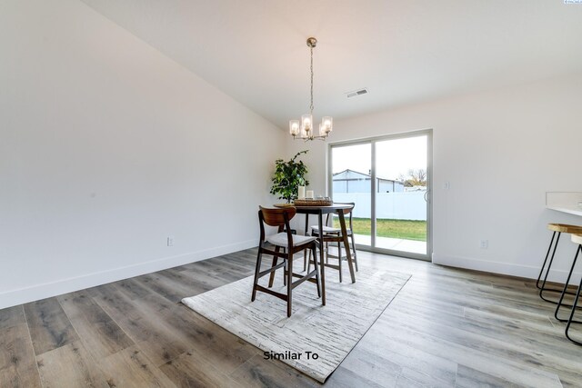 2880 S Osborne St, Kennewick, WA 99338 - dining space with a notable chandelier, baseboards, visible vents, and wood finished floors