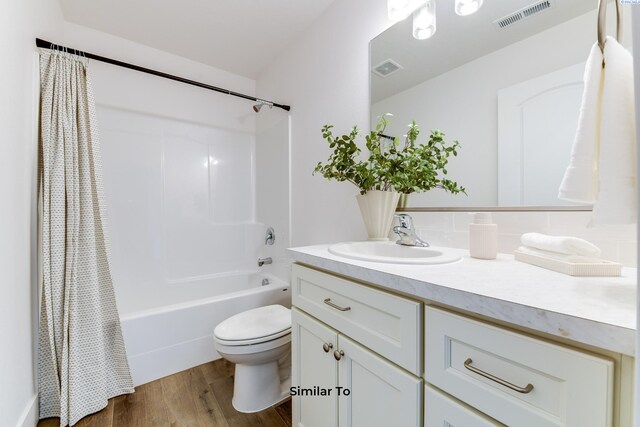 2880 S Osborne St, Kennewick, WA 99338 - bathroom with vanity, visible vents, toilet, shower / bath combo, and wood finished floors