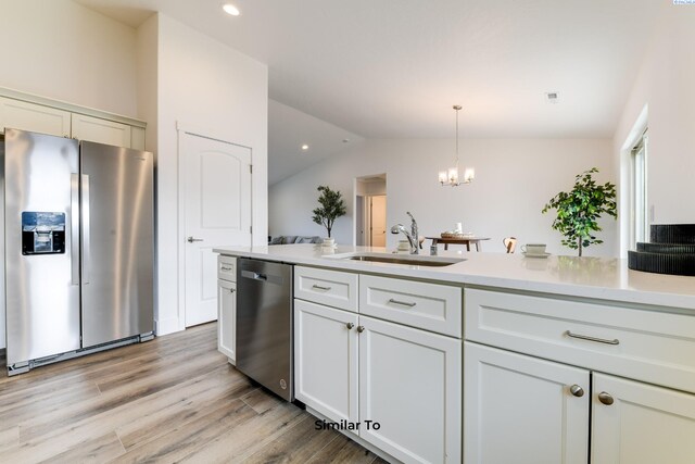 2880 S Osborne St, Kennewick, WA 99338 - kitchen featuring a notable chandelier, a sink, light countertops, appliances with stainless steel finishes, and lofted ceiling