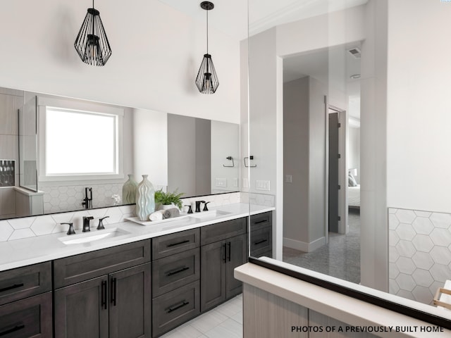 bathroom with tasteful backsplash and vanity