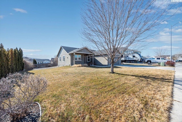 view of front of home with concrete driveway and a front yard