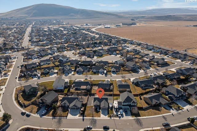 view of property location featuring a mountain backdrop and nearby suburban area