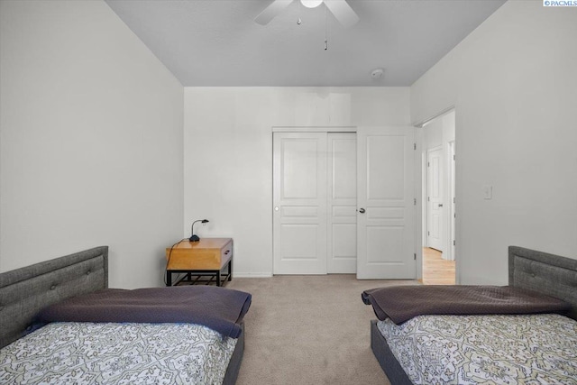 carpeted bedroom featuring a closet and a ceiling fan