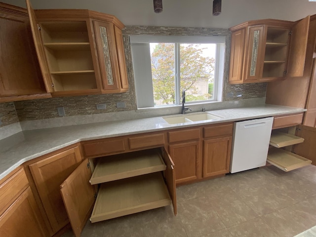 2665 Maidstone St, Richland, WA 99354 - kitchen with open shelves, white dishwasher, a sink, tasteful backsplash, and brown cabinets