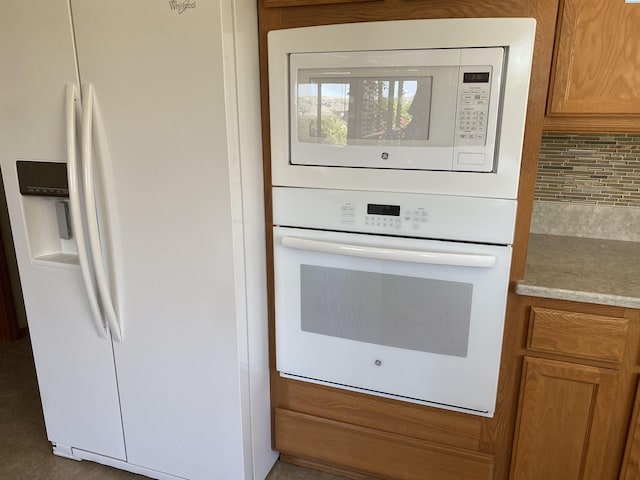 2665 Maidstone St, Richland, WA 99354 - kitchen view of white appliances, backsplash, brown cabinets, and light countertops