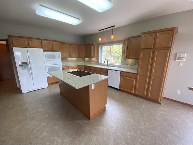 2665 Maidstone St, Richland, WA 99354 - kitchen with white appliances, a sink, backsplash, a kitchen island, and brown cabinetry