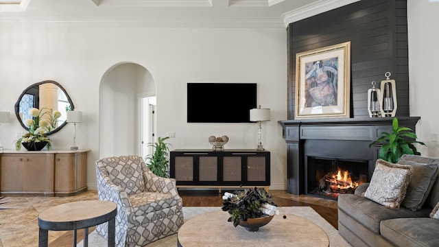 3304 Sorento Ct, Pasco, WA 99301 - living room featuring arched walkways, ornamental molding, a lit fireplace, and baseboards