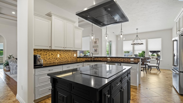 3304 Sorento Ct, Pasco, WA 99301 - kitchen featuring ventilation hood, appliances with stainless steel finishes, a sink, dark cabinets, and tasteful backsplash