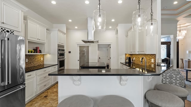 3304 Sorento Ct, Pasco, WA 99301 - kitchen featuring appliances with stainless steel finishes, dark countertops, tasteful backsplash, a kitchen breakfast bar, and recessed lighting