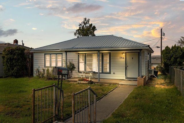 view of front of property featuring a lawn and covered porch