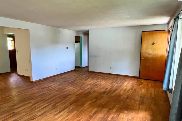 empty room with wood finished floors and baseboards