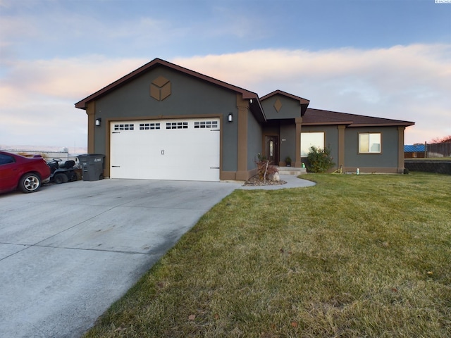 view of front of property featuring a garage and a yard