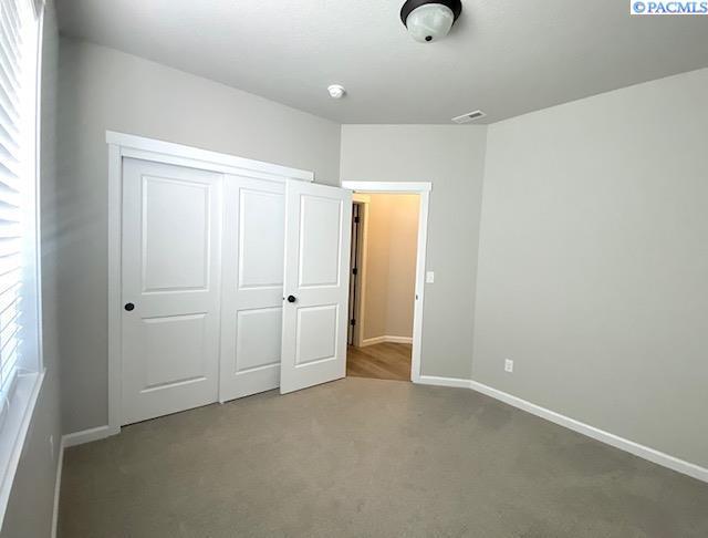 1409 Centennial Ave, Sunnyside, WA 98944 - unfurnished bedroom with carpet and a closet