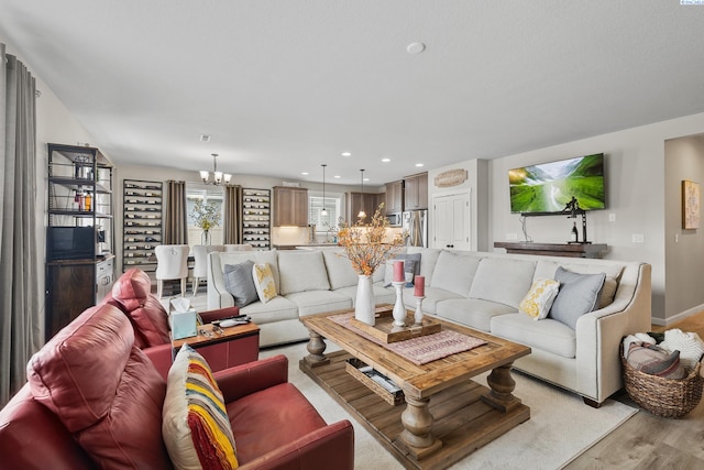 living room featuring an inviting chandelier and light wood-type flooring