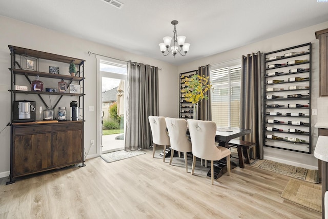 1409 Centennial Ave, Sunnyside, WA 98944 - dining room with a chandelier, light wood-style floors, and plenty of natural light