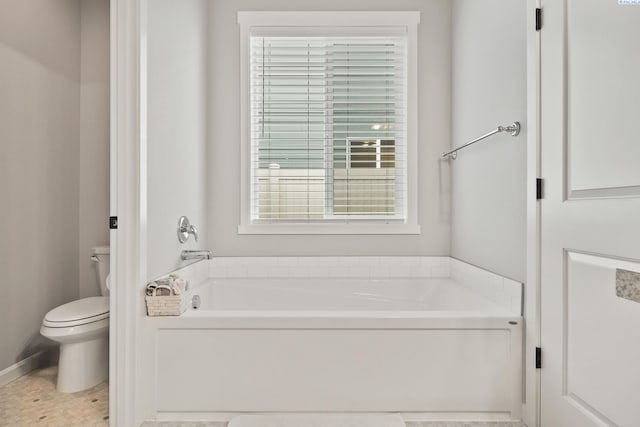 bathroom featuring a bathtub and toilet