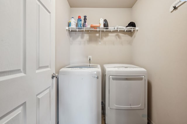 washroom featuring washing machine and clothes dryer and laundry area