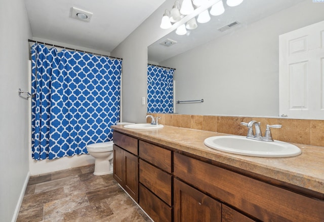 full bath with double vanity, a sink, stone finish floor, and visible vents