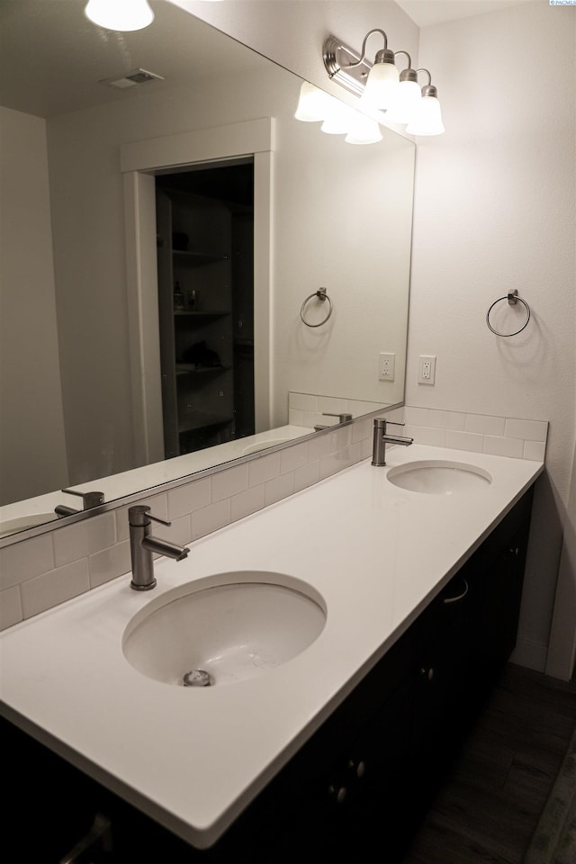 bathroom with vanity and decorative backsplash